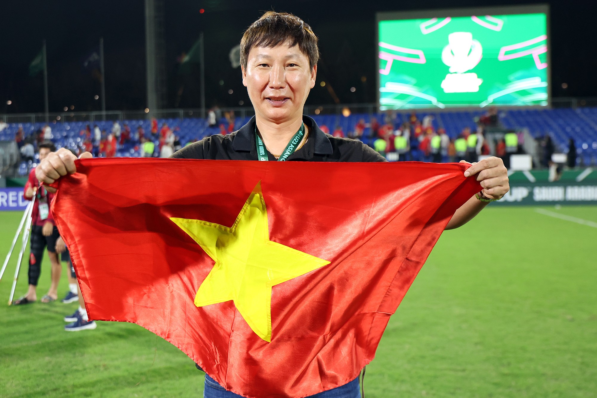 HLV Kim Sang Sik ăn mừng chiến thắng trước U23 Hàn Quốc cùng lá cờ Việt Nam.